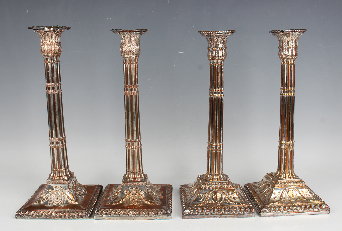 A pair of George III Sheffield plate cluster column candlesticks, each with a detachable nozzle on a