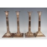 A pair of George III Sheffield plate cluster column candlesticks, each with a detachable nozzle on a