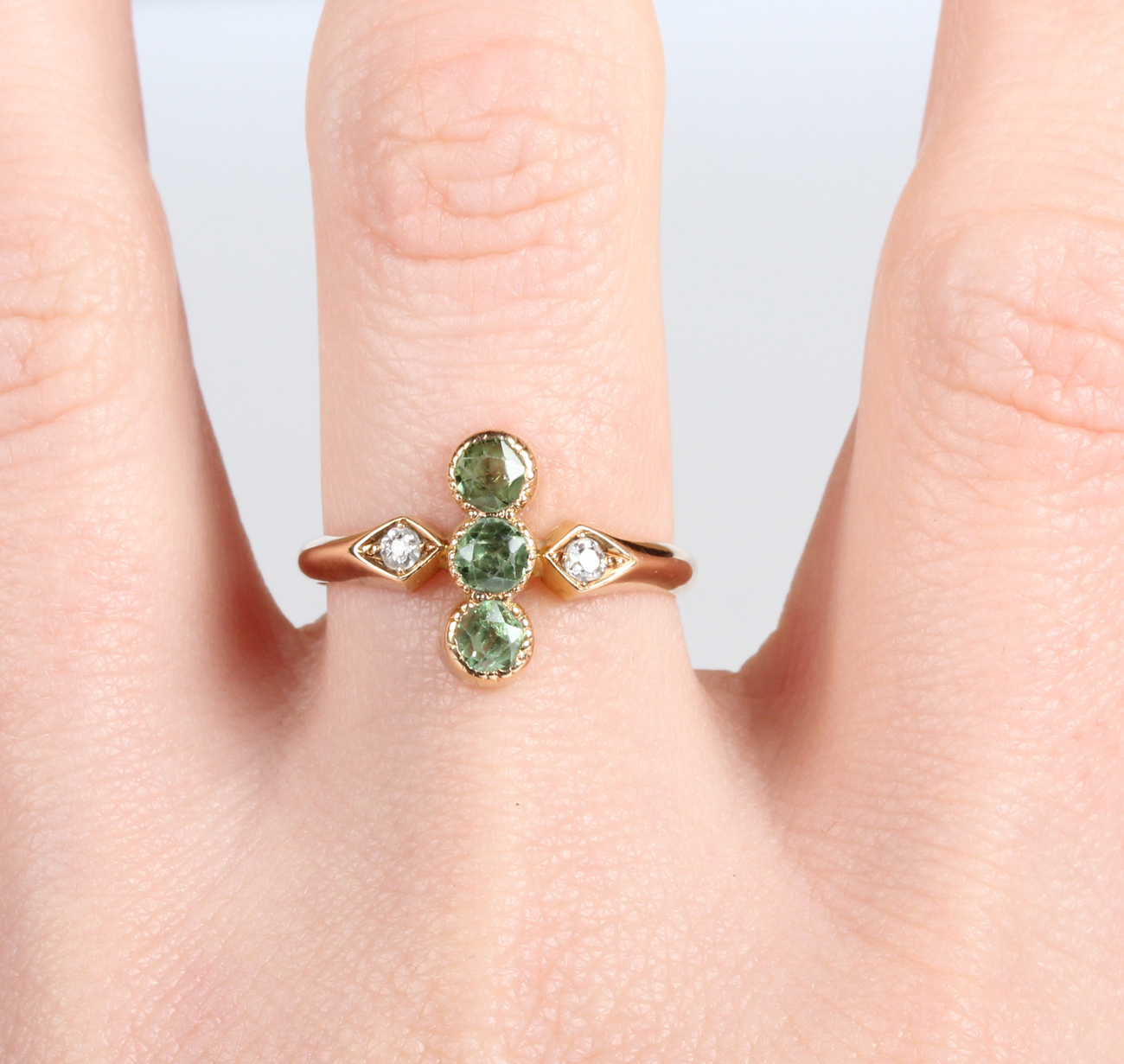 A gold, demantoid garnet and diamond ring, early 20th century, collet set with three circular cut - Image 2 of 5