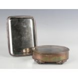 A George V silver oval jewellery box, the hinged lid with bellflower border, on scroll feet,
