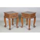 A pair of 20th century South-east Asian elm lamp tables, each fitted with a single drawer and finely