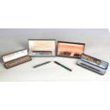 A Parker Volumatic fountain pen with striped body and a small collection of other pens and
