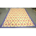 An Indian cotton dhurrie, 20th century, the cream field with an overall lattice of pink flowerheads,