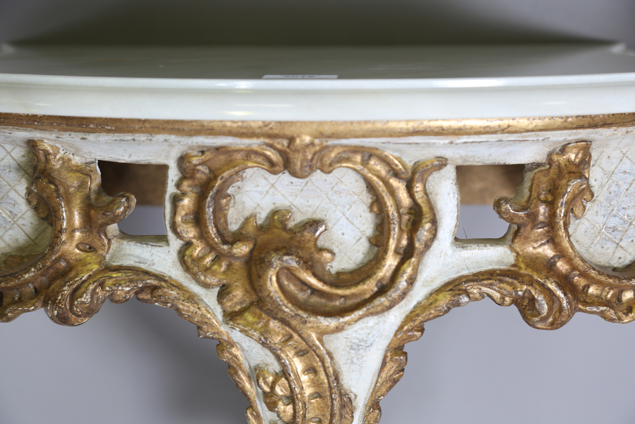 A pair of modern Rococo style white and gilt painted carved wooden console tables with shaped - Image 15 of 15