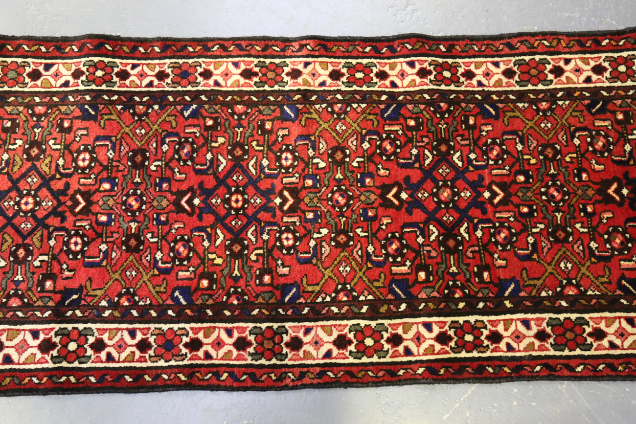 A Malayer runner, North-west Persia, mid/late 20th century, the red field with an overall floral - Image 7 of 9