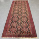 An Afghan wide runner, mid/late 20th century, the charcoal field with columns of stepped guls,