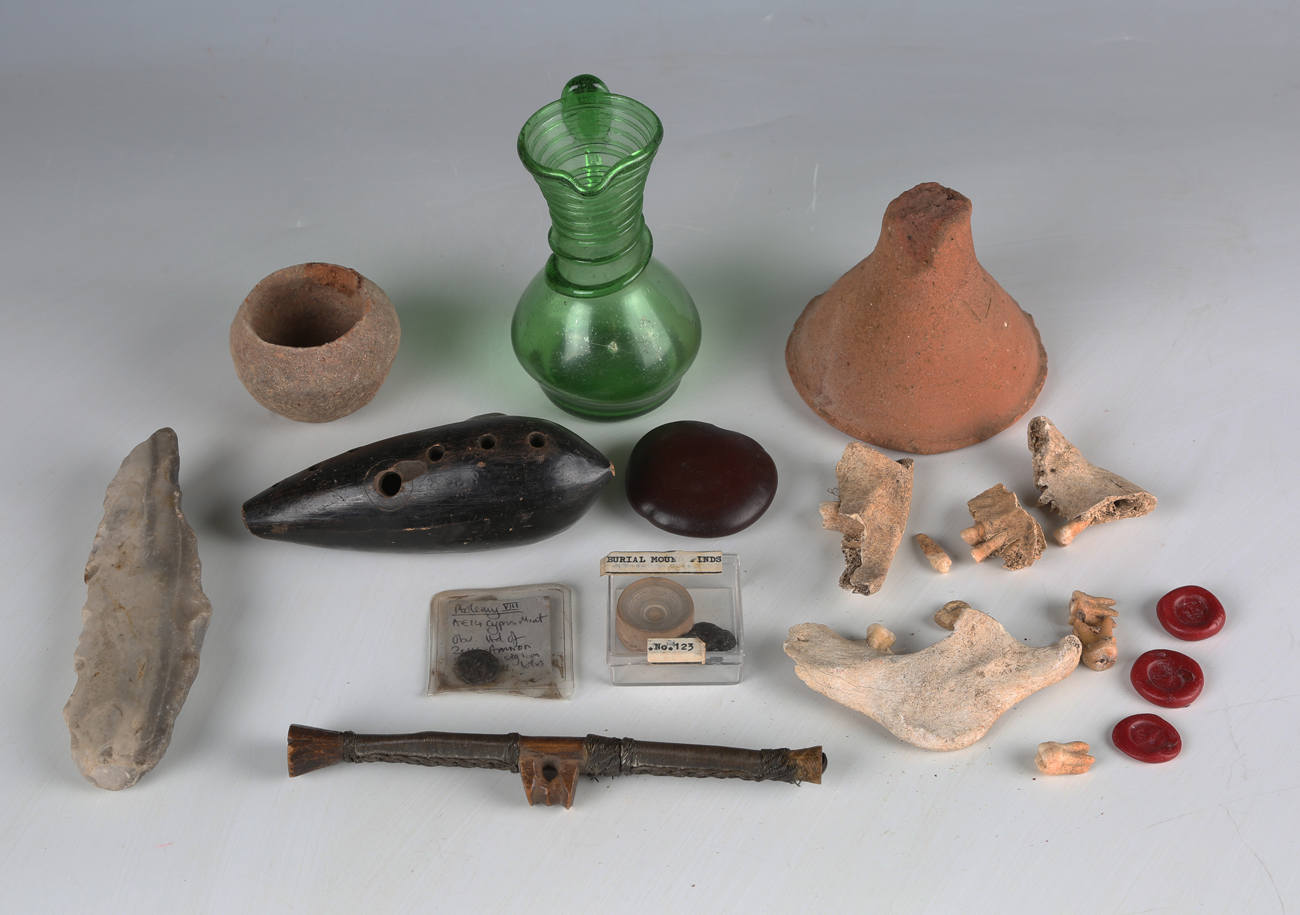 A group of antiquities and other collectors' items, including a Paleolithic flint fabricator tool,