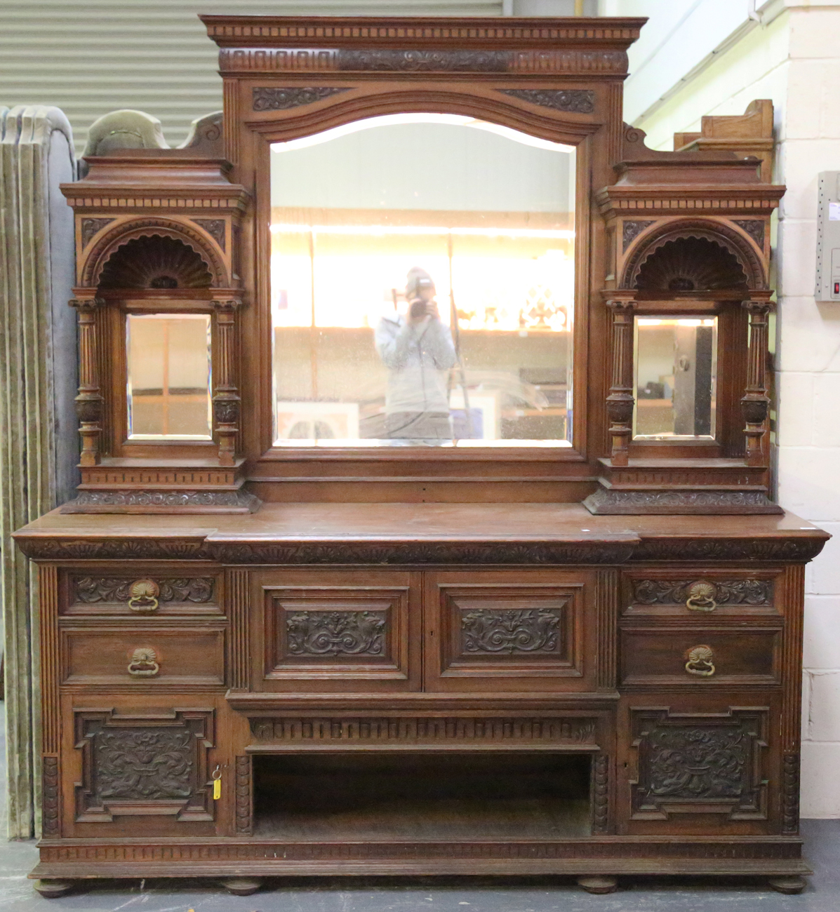 A large late Victorian walnut breakfront sideboard by James Shoolbred & Co, the mirror back with a