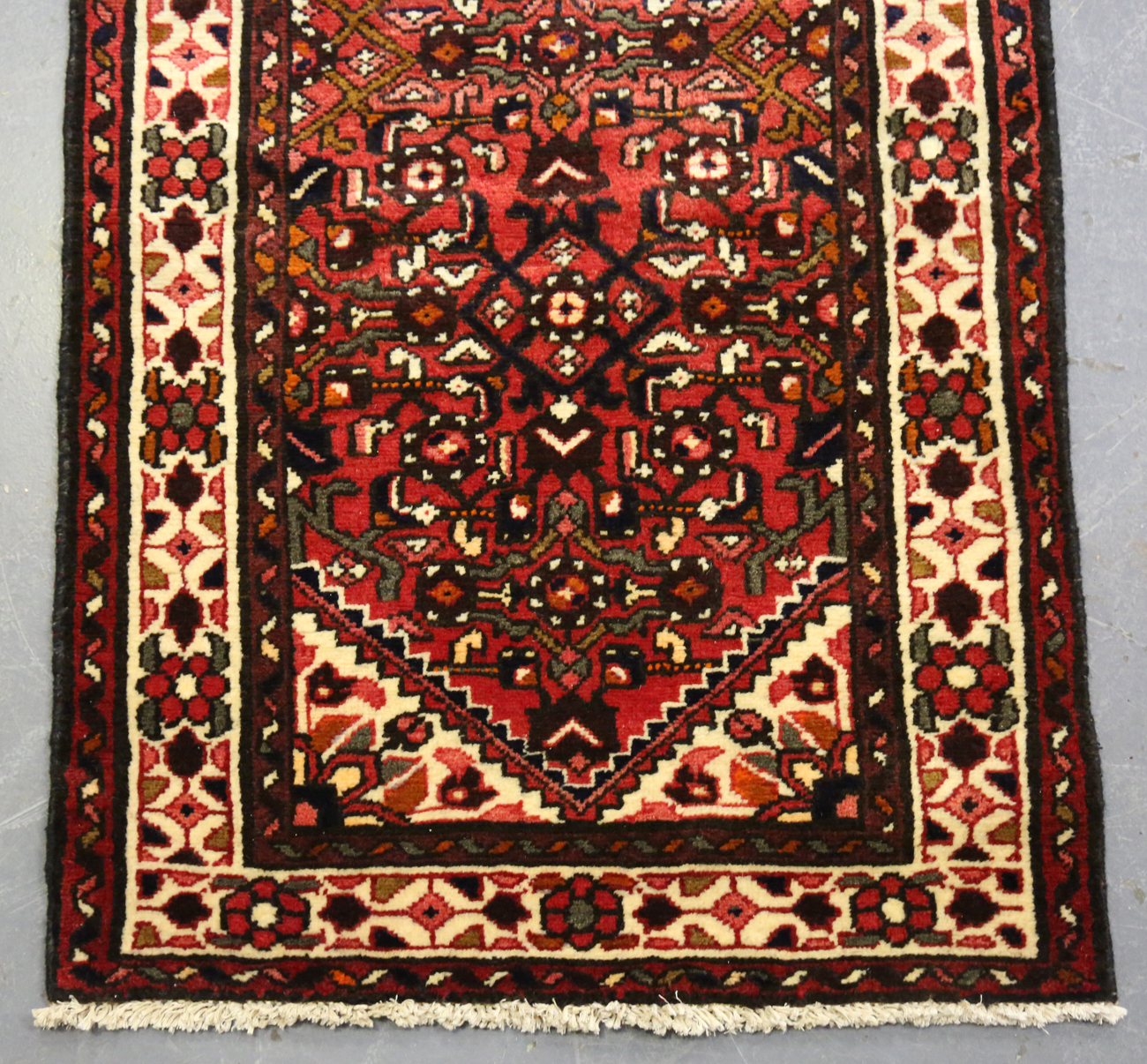 A Malayer runner, North-west Persia, mid/late 20th century, the red field with an overall floral