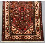 A Malayer runner, North-west Persia, mid/late 20th century, the red field with an overall floral