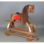 A modern carved oak rocking horse by Stevenson Brothers, finely modelled and fitted with leather and