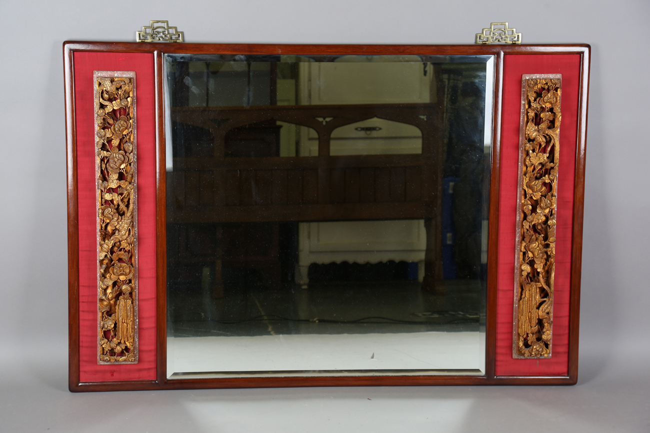 A 20th century Chinese hardwood framed rectangular wall mirror, the square bevelled glass plate