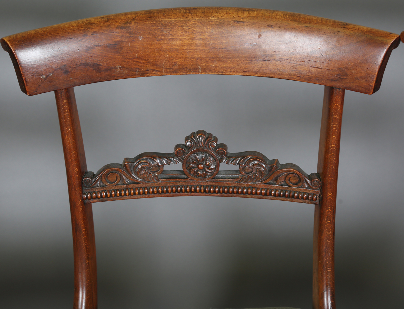 A set of seven Regency simulated rosewood beech framed dining chairs with carved centre rails, - Image 4 of 11