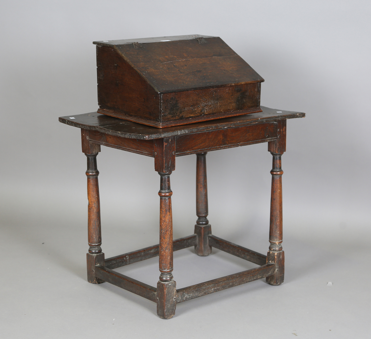 A 17th century oak bible box, the hinged sloping lid enclosing three drawers, width 53cm, depth