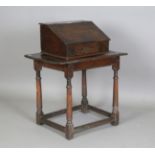 A 17th century oak bible box, the hinged sloping lid enclosing three drawers, width 53cm, depth