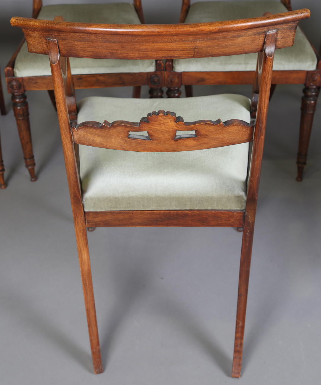 A set of seven Regency simulated rosewood beech framed dining chairs with carved centre rails, - Image 6 of 11