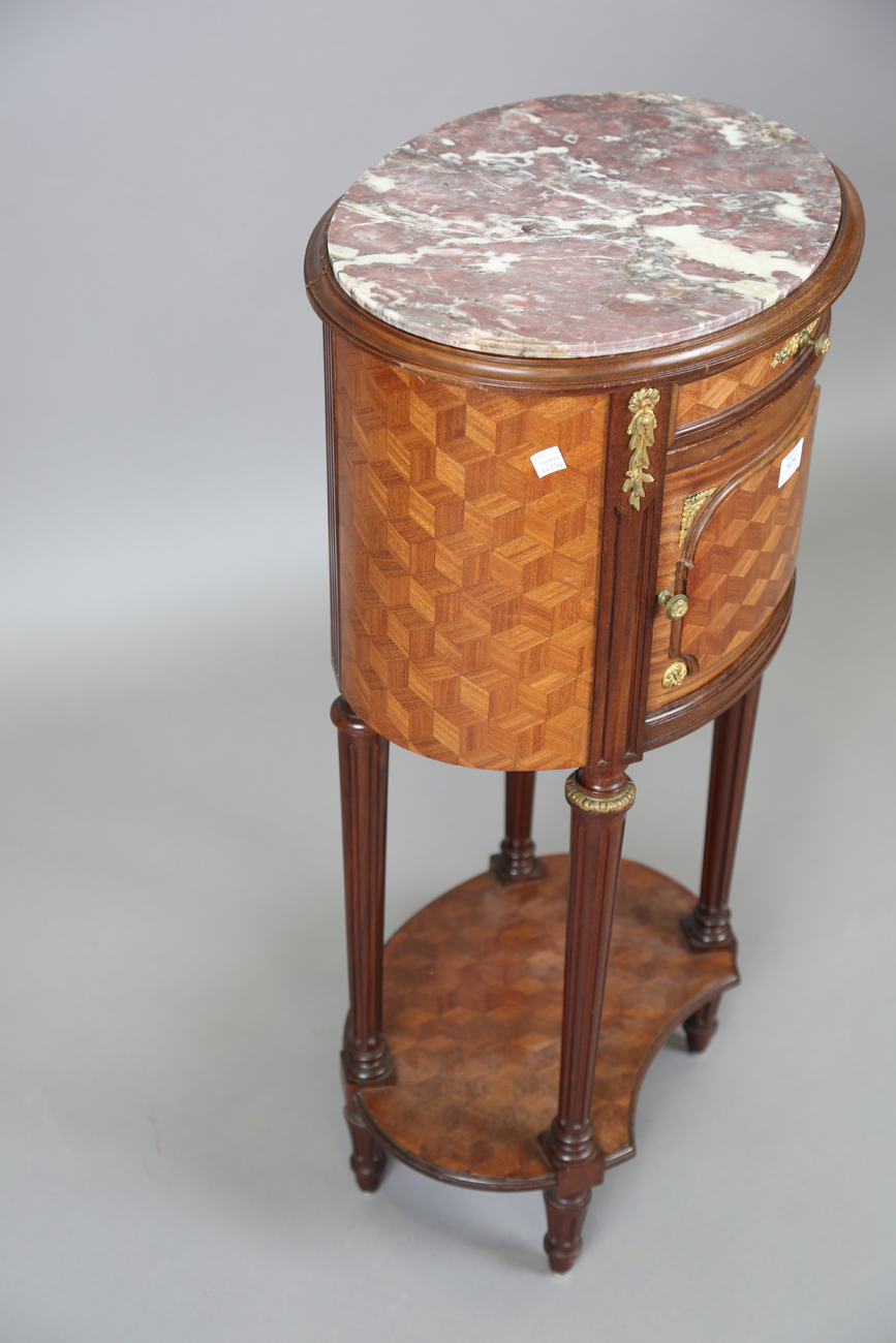 An early 20th century French parquetry kingwood oval bedside cabinet with gilt metal mounts and - Image 4 of 11