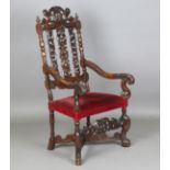 A 19th century Continental walnut armchair, the pierced back finely carved with foliage flanked by