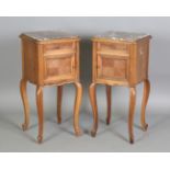 A pair of early 20th century French walnut bedside cabinets with inset rouge marble tops, height