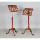 A pair of modern Victorian style hardwood music stands, the adjustable stems on tripod supports,