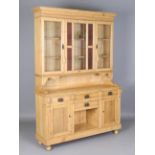 A 20th century pine kitchen dresser, the glazed top with a fixed stained glass panel, the base