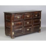 A late 17th century oak dresser base, the three drawers above three dummy drawers flanked by