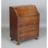 A 20th century Queen Anne style oak bureau of small proportions, raised on bun feet, height 102cm,