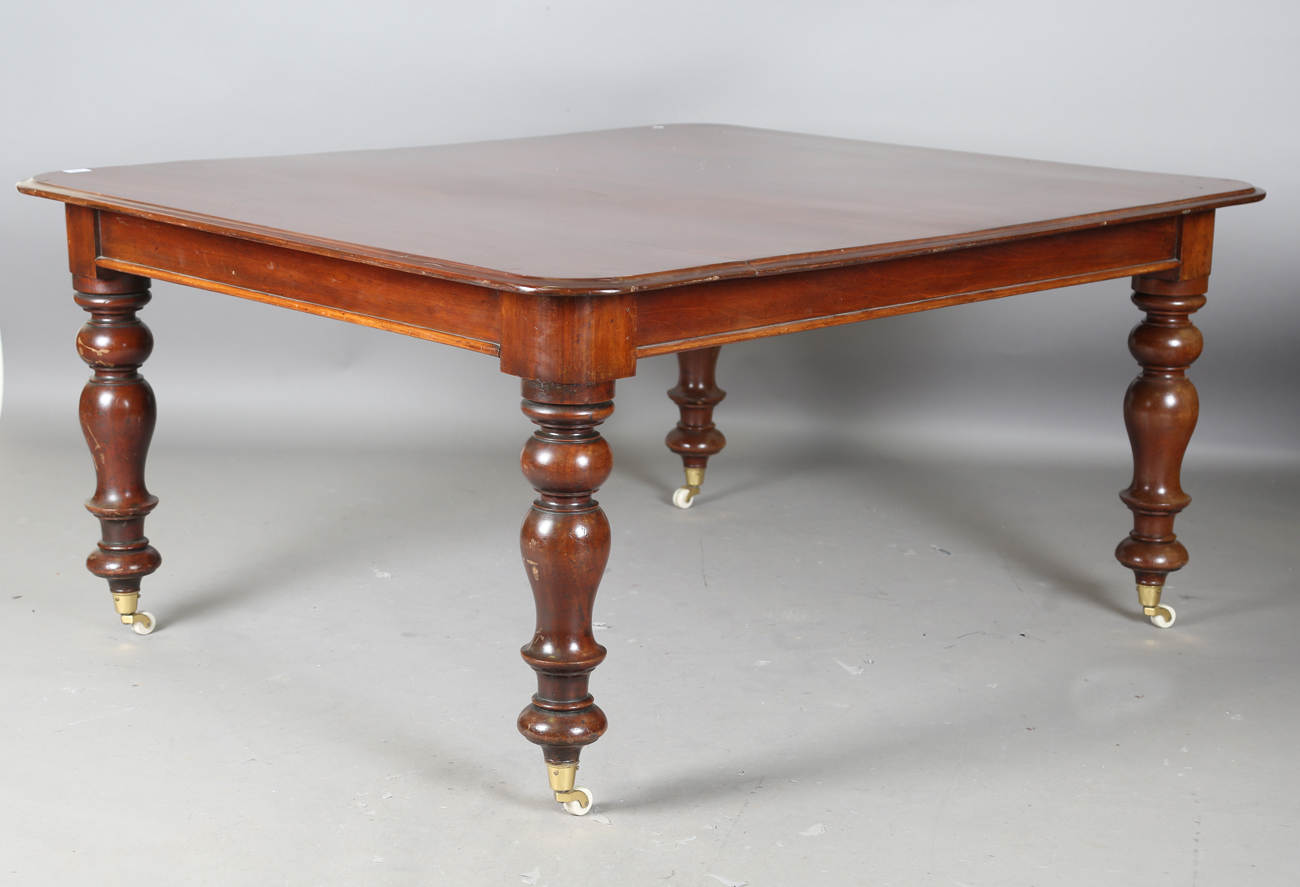 A Victorian mahogany dining table, the moulded top on turned baluster legs and castors, height 72cm,