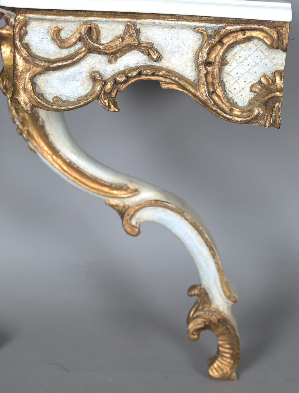 A pair of modern Rococo style white and gilt painted carved wooden console tables with shaped - Image 5 of 15