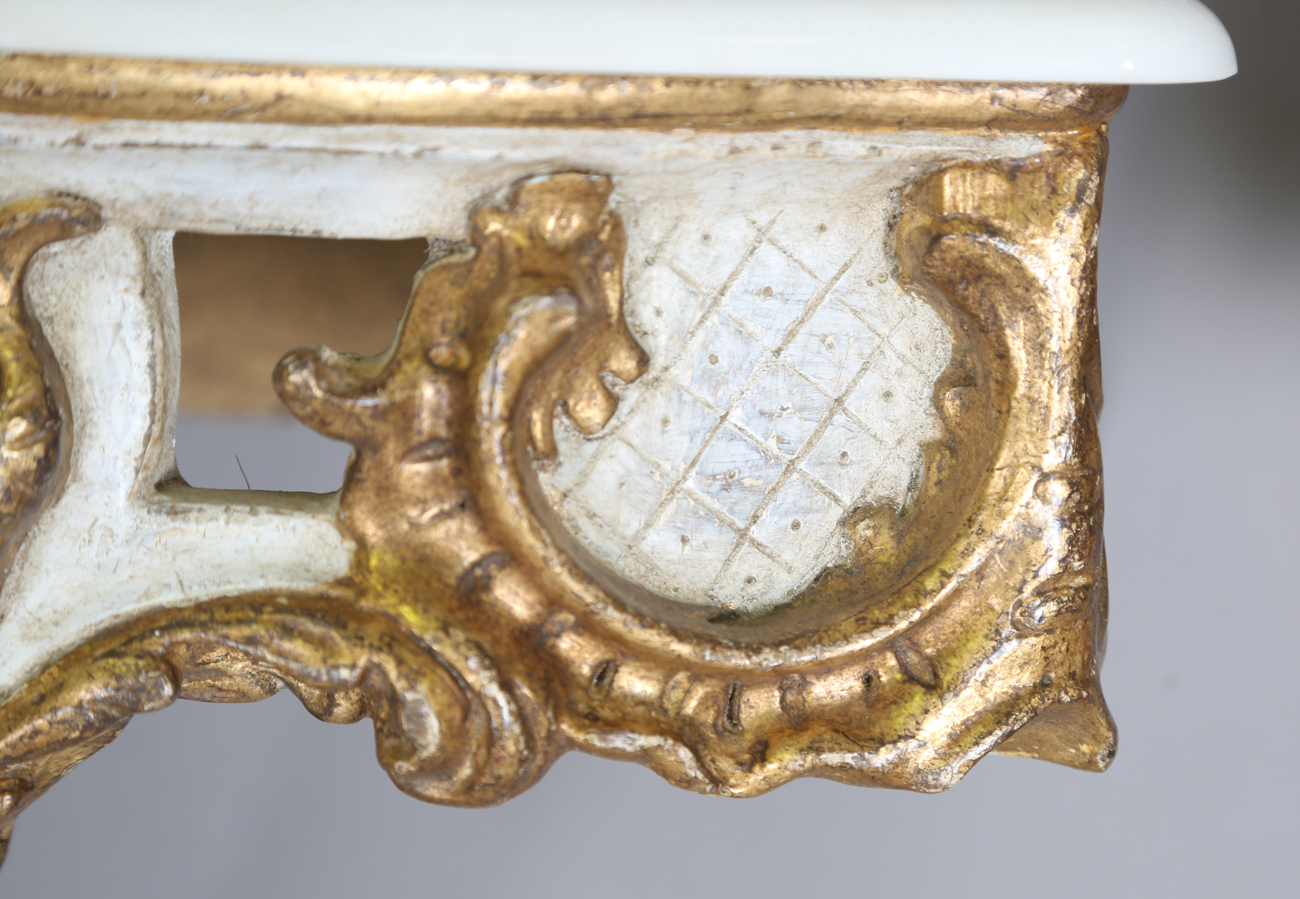 A pair of modern Rococo style white and gilt painted carved wooden console tables with shaped - Image 14 of 15