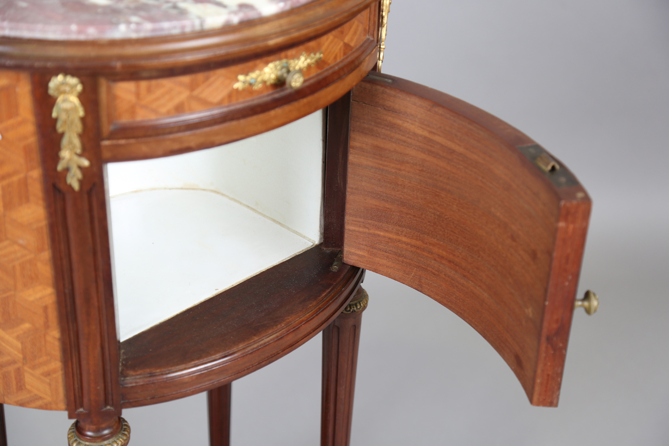 An early 20th century French parquetry kingwood oval bedside cabinet with gilt metal mounts and - Image 7 of 11