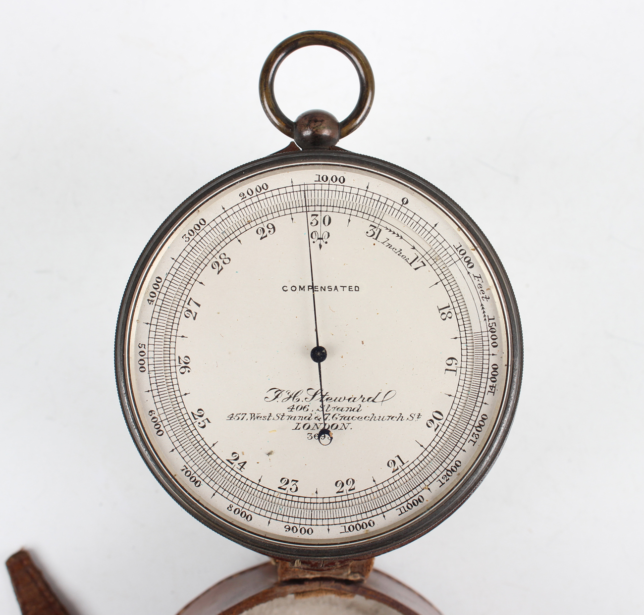 An early 20th century anodized brass cased pocket barometer altimeter, the silvered circular dial