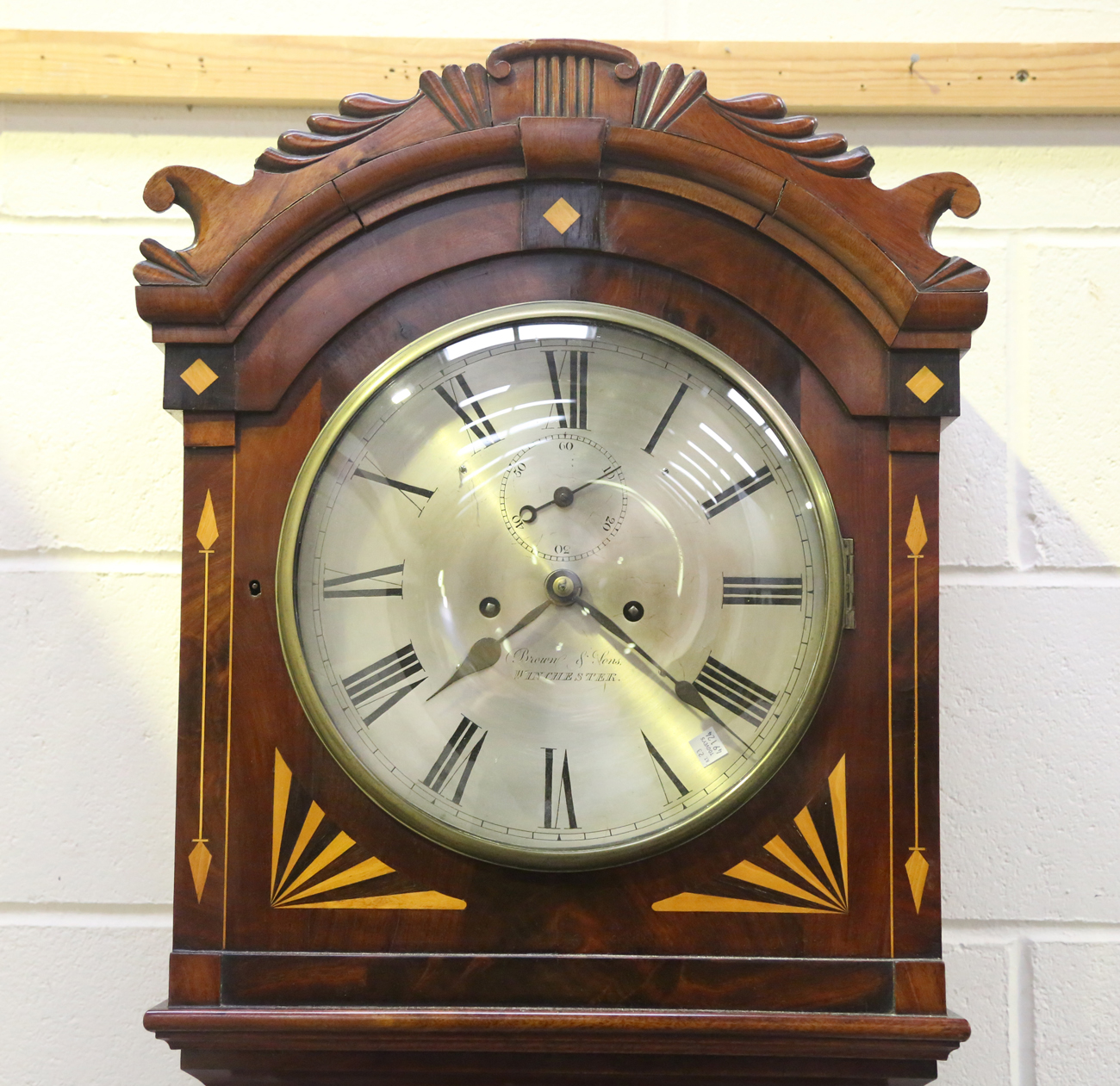 A 19th century mahogany longcase clock with eight day movement striking on a bell, the 12-inch