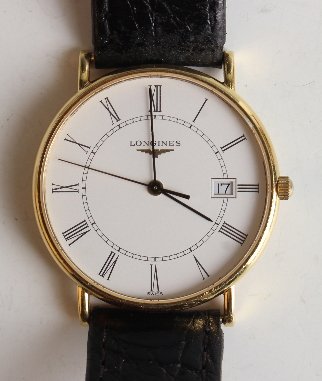 A Longines 18ct gold circular cased gentleman's wristwatch with quartz movement, the signed white