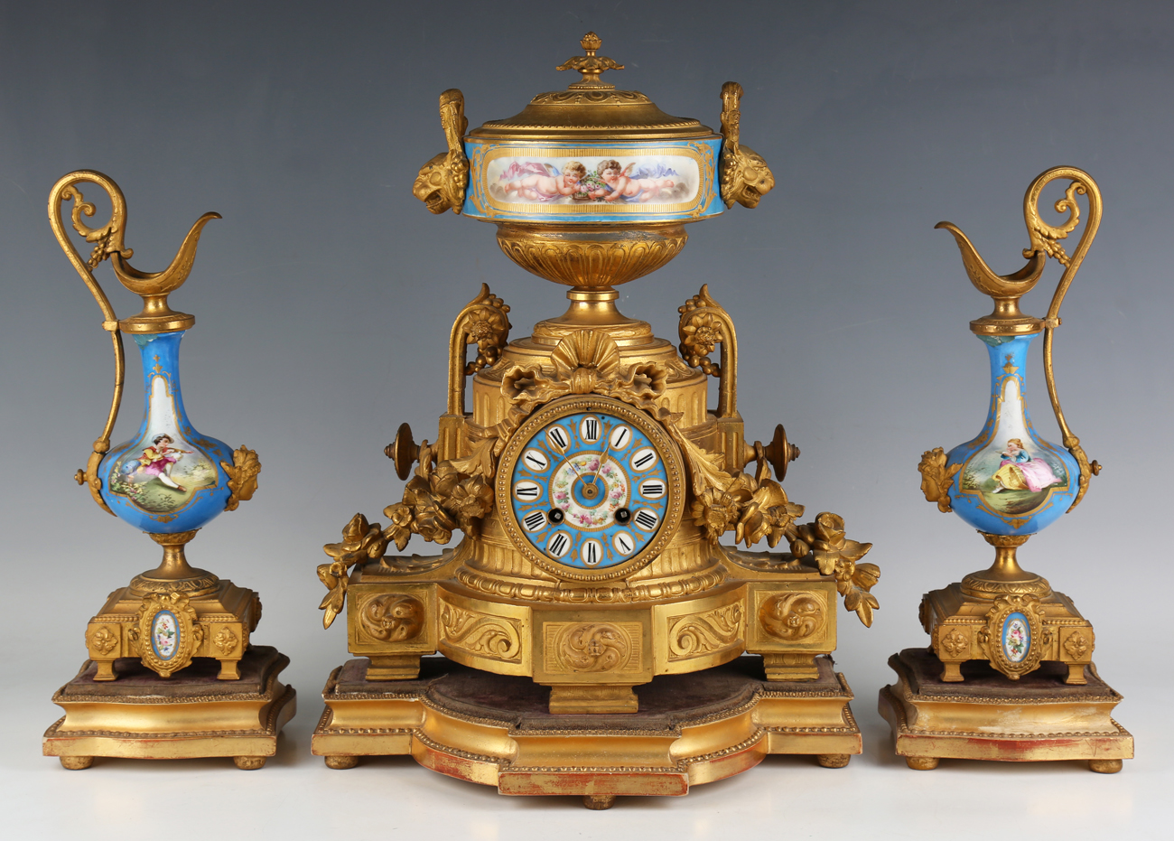 A late 19th century French gilt metal and porcelain mantel clock with eight day movement striking on