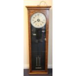 A George V National Electric oak cased electric master clock, the painted circular dial with black