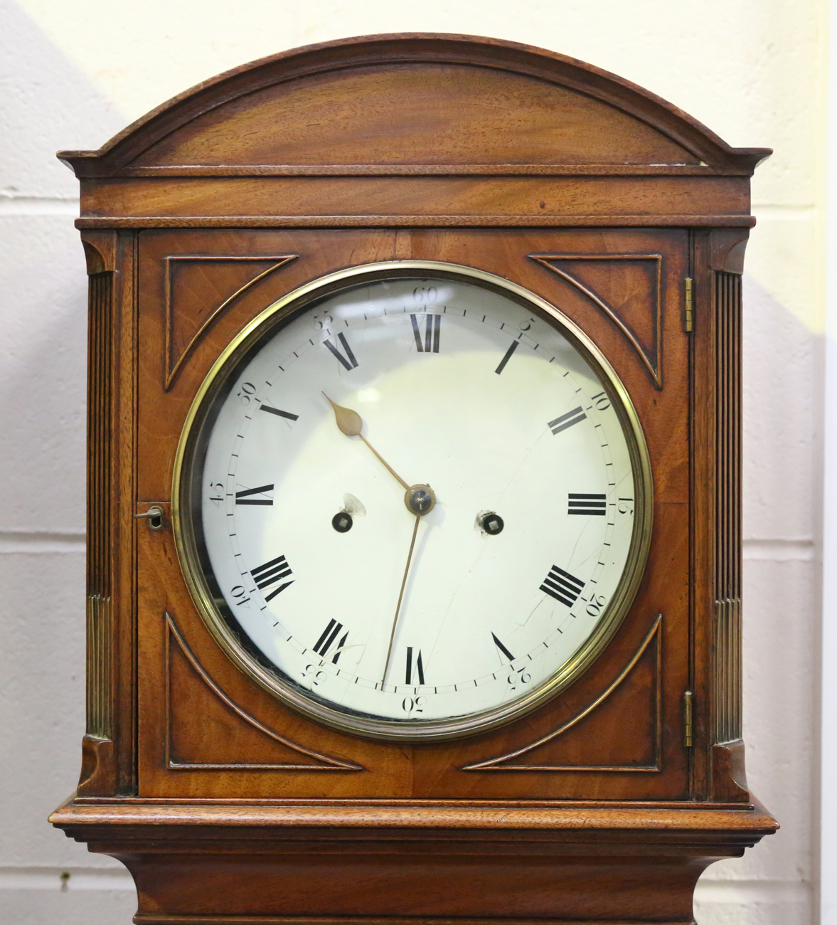 An early 19th century mahogany longcase clock with eight day movement striking hours on a bell,