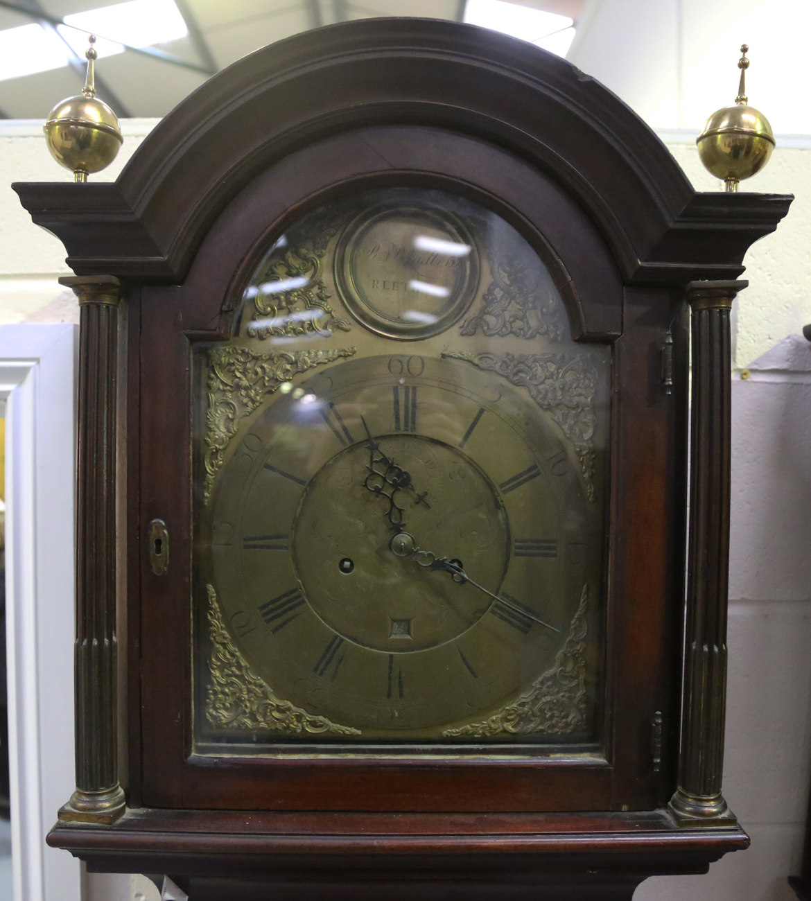 A George III mahogany longcase clock with eight day movement striking on a bell, the 12-inch brass