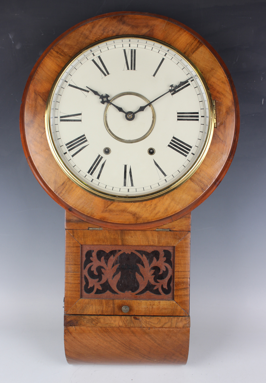 A late 19th century American walnut drop dial wall clock with eight day movement striking on a bell,