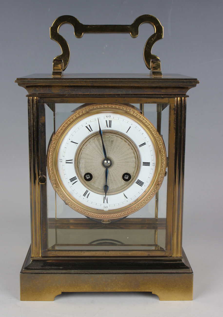 A 20th century French lacquered brass four glass mantel clock, the eight day movement with