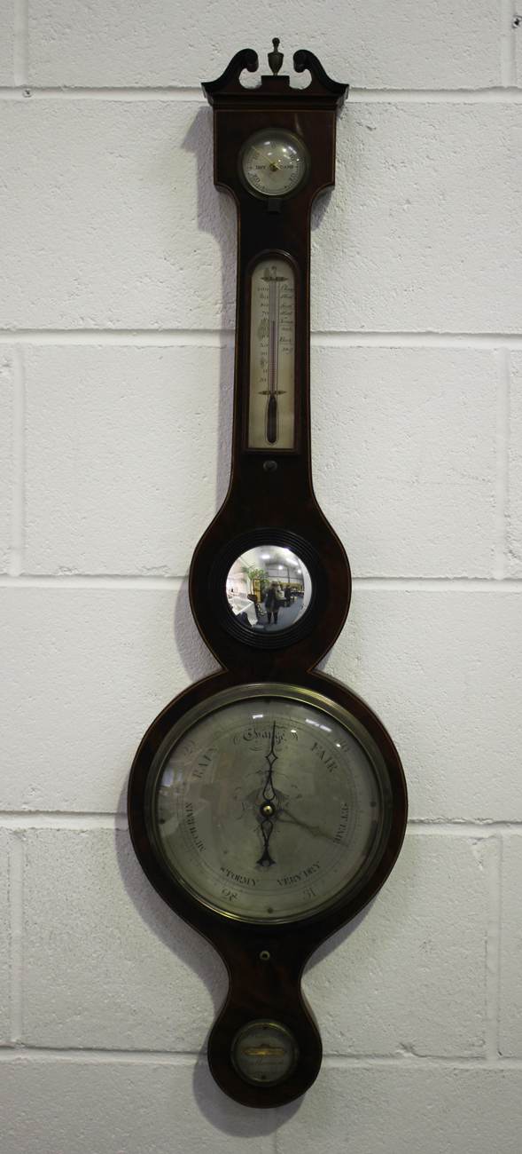 A George III mahogany wheel barometer with silvered dials, hygrometer, alcohol thermometer, convex