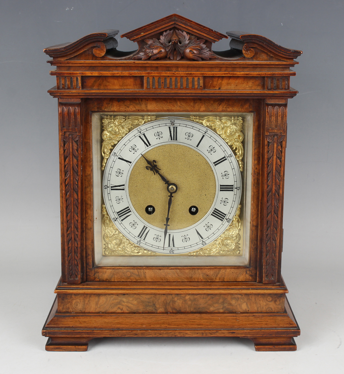 A late 19th century walnut mantel clock with Lenzkirch eight day movement striking on a gong, the