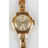 An Avia Cadette 9ct gold lady's bracelet wristwatch, the signed silvered circular dial with gilt