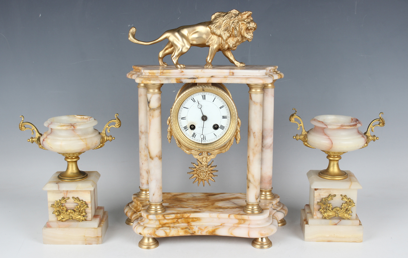 A late 19th/early 20th century gilt metal mounted marble portico clock with eight day movement