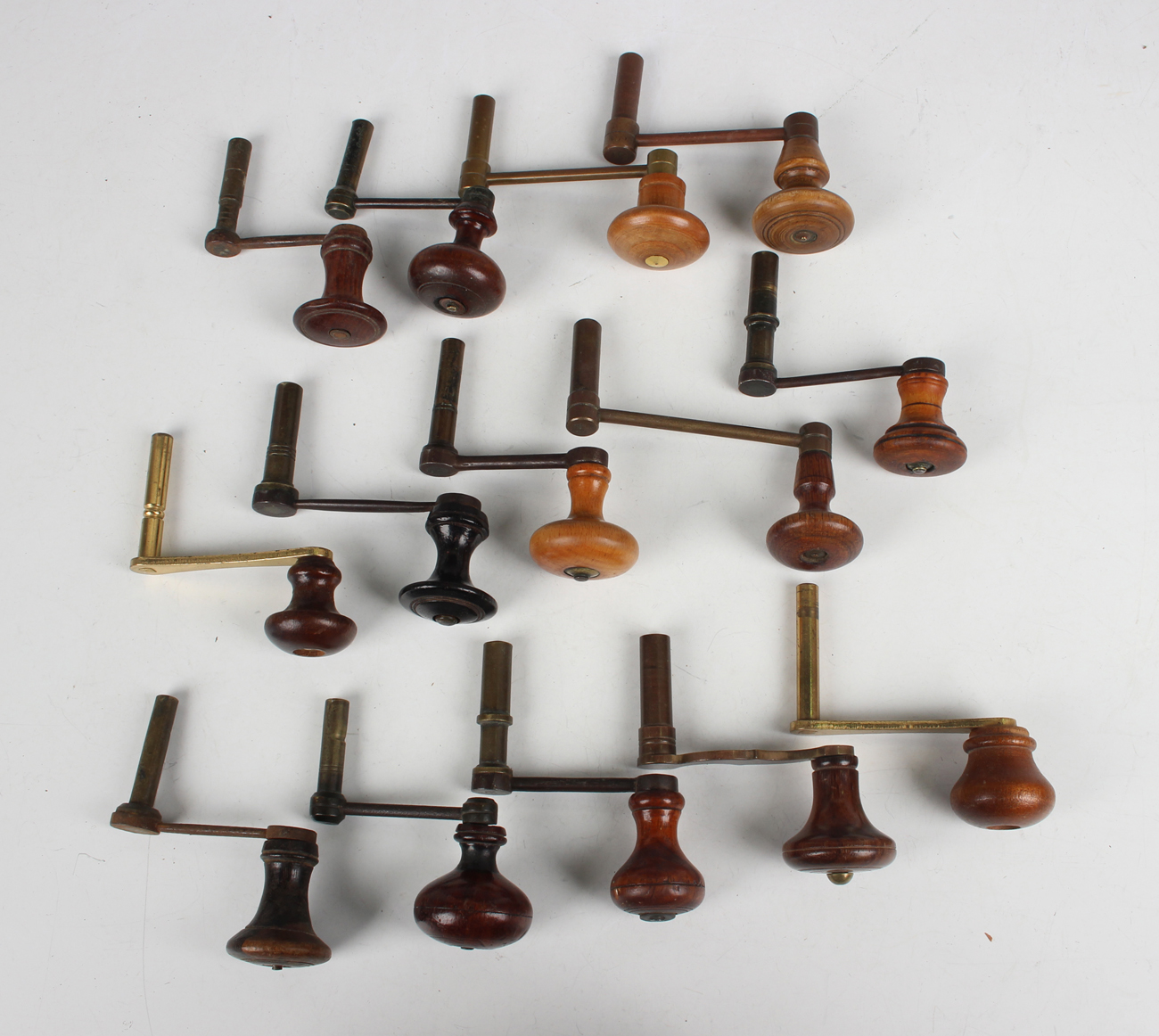 A collection of fourteen 19th century and later longcase clock winders, each with turned wood