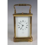 An early 20th century French lacquered brass cased carriage clock with eight day movement striking