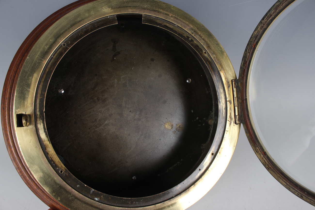 An early 20th century brass circular cased ship's bulkhead type timepiece, the brass four pillar - Image 4 of 9