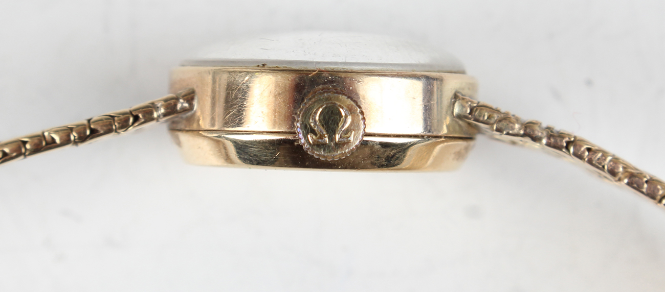 An Omega 9ct gold lady's bracelet wristwatch, the signed circular silvered dial with gilt baton hour - Image 11 of 15