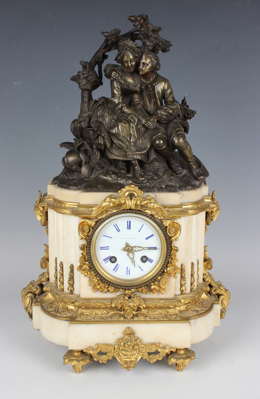 A late 19th century French brown patinated bronze, ormolu and white marble mantel clock, the eight