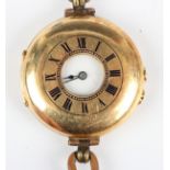 An 18ct gold circular half hunting cased wristwatch, the unsigned jewelled movement numbered '